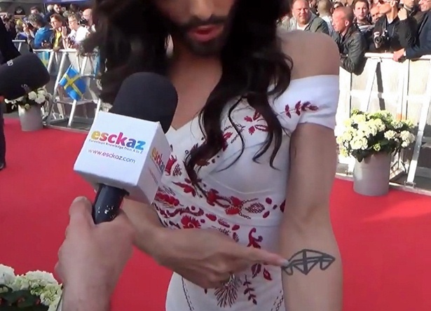 conchita wurst tattoo of mother father brother initials